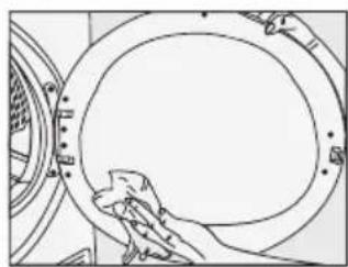 Line drawing of a hand cleaning a circular mechanical component (no text or symbols)