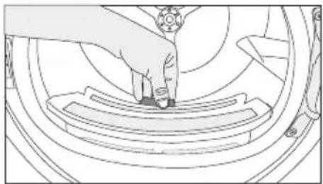 Line drawing of a hand pressing down on a mechanical component (no text or symbols)