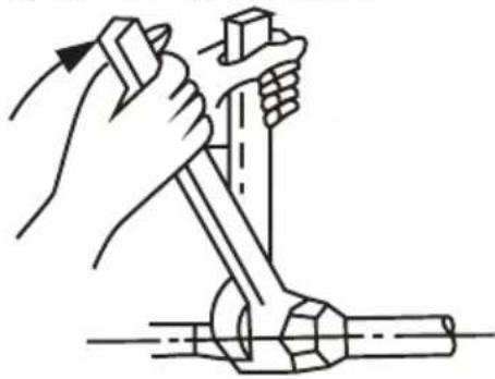 Line drawing of hands using a tool to lift a mechanical component (no text or symbols)