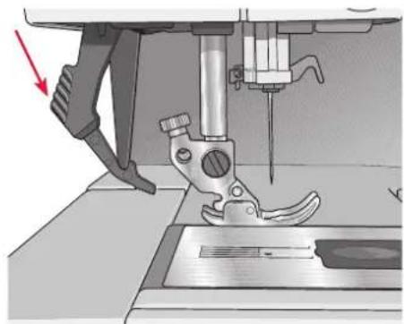 Close-up of a sewing machine needle stitching a metal workpiece, with a red arrow indicating the process (no text or symbols visible)