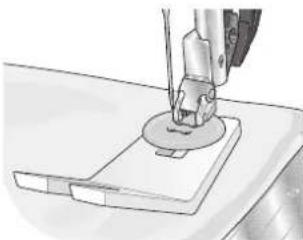 Close-up of a sewing machine needle stitching fabric (no text or symbols visible)