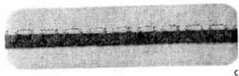 Close-up of a textured surface with a dark horizontal band and faint linear markings (no text or symbols)