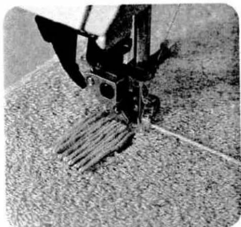 Close-up of a mechanical tool with textured surface and lever mechanism (no visible text or symbols)