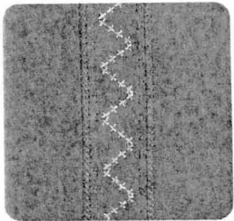 Close-up of a textured surface with vertical dashed lines and a wavy white line overlay (no text or symbols)