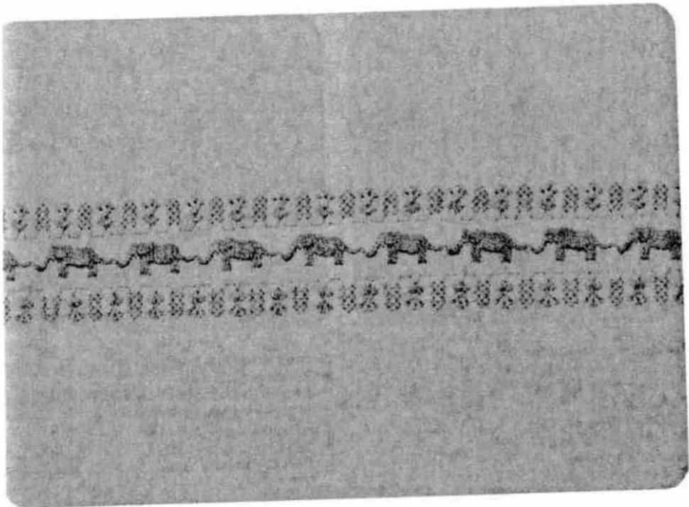 Ancient Chinese manuscript with vertical column of inscribed text and a row of elephant figures, likely from a historical or literary manuscript.