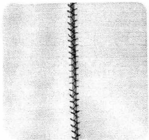 Close-up of a vertical seam or crack on a textured fabric background (no text or symbols)