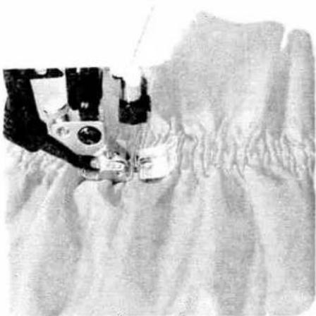 Close-up of a sewing machine stitching fabric (no visible text or symbols)
