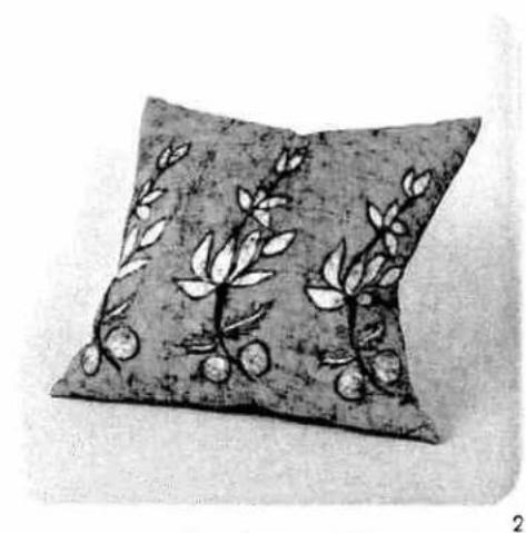 Black-and-white illustration of a cushion with floral patterns and fruit motifs (no text or symbols)