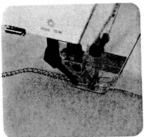 Close-up of a mechanical device with a curved track and components, no visible text or symbols