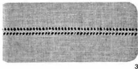 Close-up of a textured fabric with a horizontal dotted line and small circular indentations (no text or symbols)