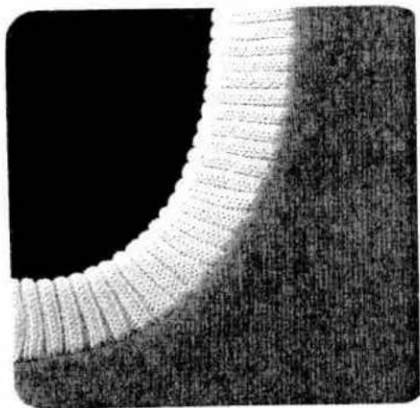Close-up of a textured fabric surface with a curved, layered structure against a black background (no text or symbols)