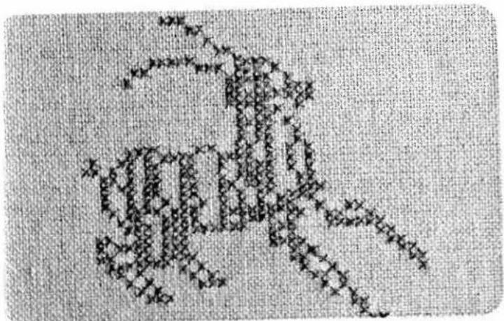 Hand-drawn sketch of a cat silhouette made from paper strips, with visible text and symbols on the left side.