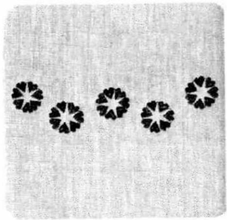 Five black starburst patterns arranged in a row on a textured gray background (no text or symbols)