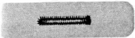 Close-up of a black cylindrical object with textured surface (no visible text or symbols)