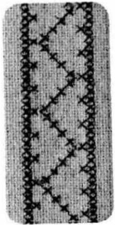 Close-up of a textured fabric with diagonal seam pattern and repeating diamond motifs (no text or symbols)