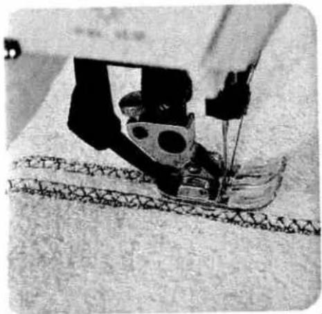 Close-up of a sewing machine needle stitching fabric (no visible text or symbols)