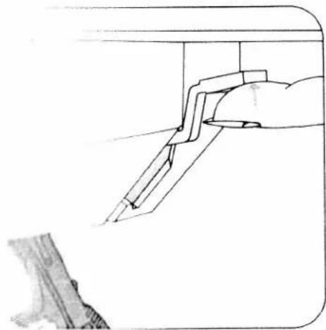Line drawing of a hand holding a tool with a bracket, no text or symbols present