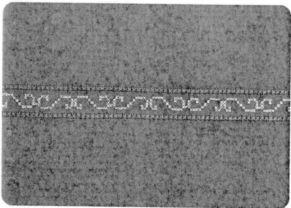 Close-up of a textured fabric with a horizontal seam and dotted pattern, no visible text or symbols.