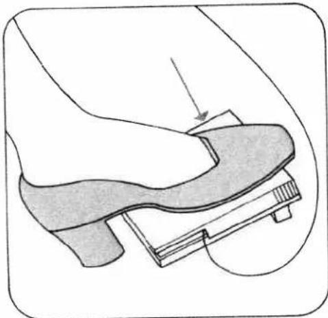 Illustration of a hand pressing down on a shoe component (no text or symbols)