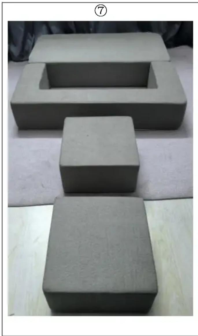 Three gray clay blocks arranged on a white surface, with one block highlighted in a recessed opening (no text or symbols visible)