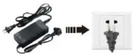 Electric charger connected to a wall-mounted socket, showing wiring and power connection (no text or symbols visible)