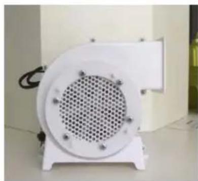 White industrial fan or vent device with a circular grille and mounting base, placed on a stand (no visible text or symbols)