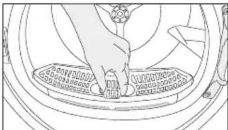 Line drawing of a hand pressing down on a circular mechanical component (no text or symbols)