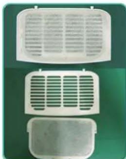 Three white plastic heat exchanger or vent vials arranged vertically on a green background (no text or symbols visible)