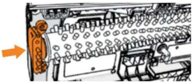 Interior view of a mechanical device showing internal components and a directional arrow (no text or symbols)