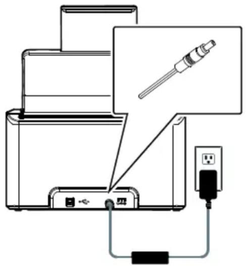 Diagram showing a device connected to a power outlet via a cable, with a pencil inserted into the top panel.