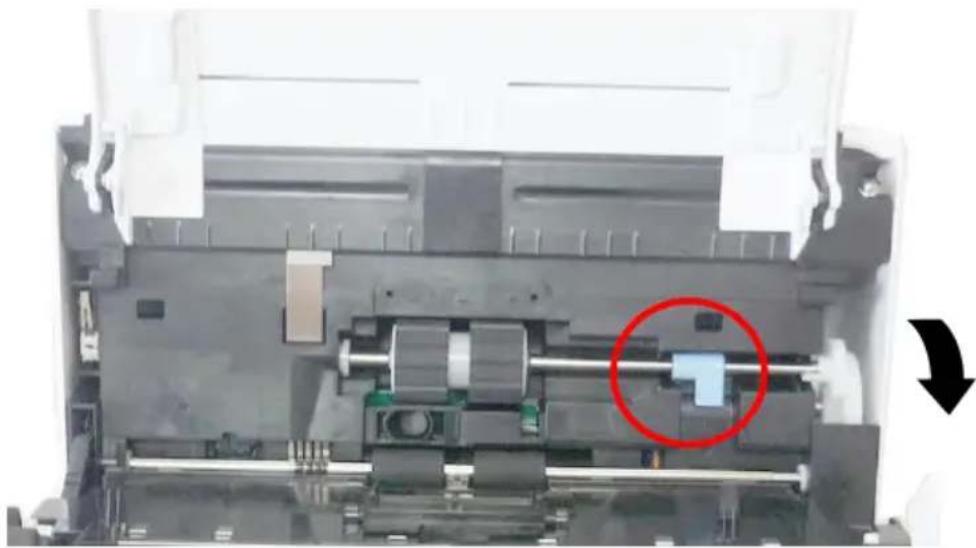 Close-up of a mechanical assembly with a highlighted component (red circle) and directional arrow, no visible text or symbols.