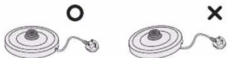 Two circular devices with a central knob and connected wires, one marked with an 'O' and the other with a cross (no text or symbols on the devices themselves)
