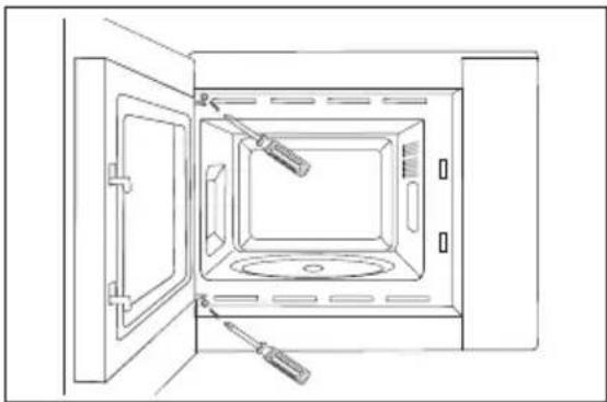 Line drawing of an open microwave oven with a screwdriver inserted, showing internal components and no text or symbols.