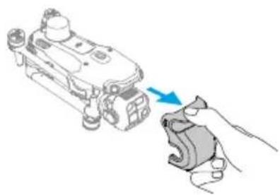 Illustration of a hand holding a small mechanical component with a blue arrow indicating direction (no text or symbols)