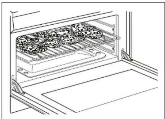 Line drawing of a kitchen appliance with three trays filled with food items, enclosed in an open drawer (no text or symbols)