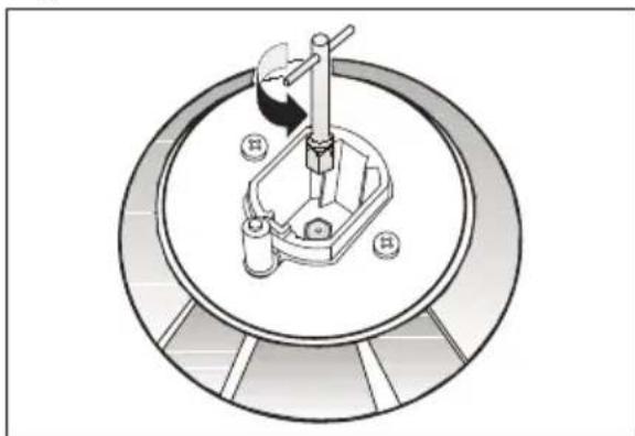 Technical diagram of a mechanical device with a central shaft and base, enclosed in a circular frame (no text or symbols)