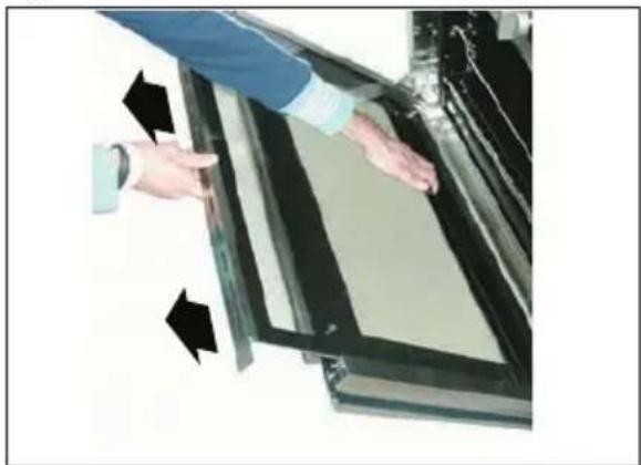 Person interacting with a transparent display panel, showing black arrows indicating movement or force (no text or symbols visible)
