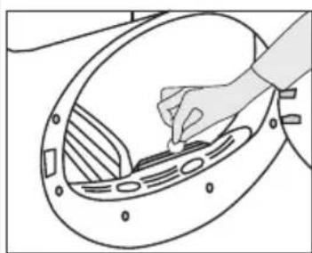 Line drawing of a hand inserting a component into a fan-shaped device (no text or symbols)