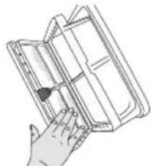 Hand holding a folded notebook or folder, no visible text or symbols