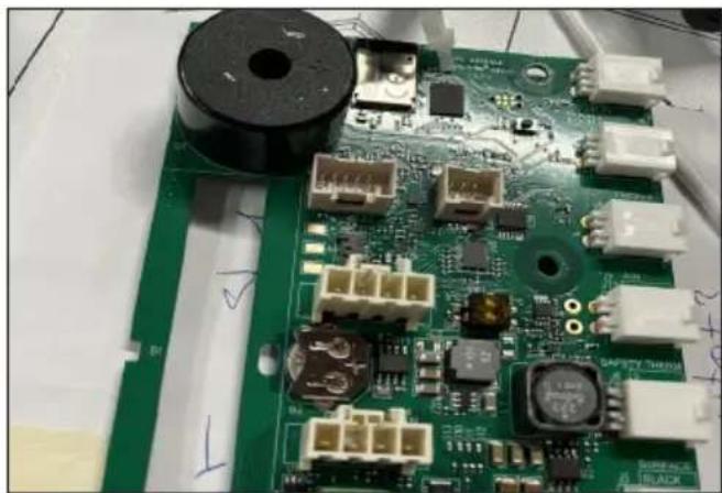 Close-up of a green printed circuit board with various electronic components and connectors (no readable text or symbols)