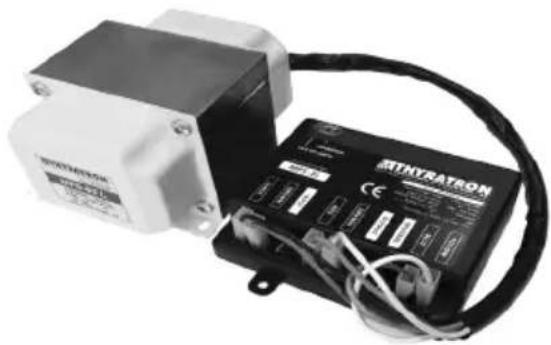 Exterior view of a modern electronic device with attached black control panel and cable (no visible text or symbols)