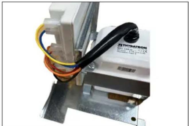 Close-up of a TINRATRON electrical component with multicolored wires and metal frame (no visible text or symbols)