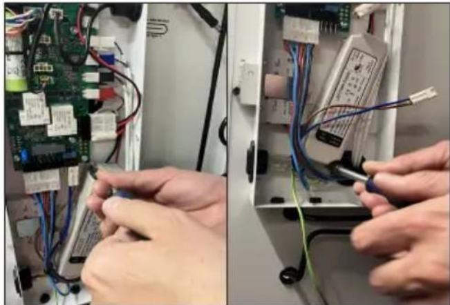 Close-up of hands working on an electronic circuit board with wires and components (no visible text or symbols)