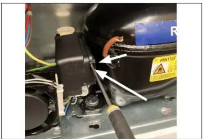 Close-up of an industrial electrical component with visible wiring and a warning label (no readable text or symbols)