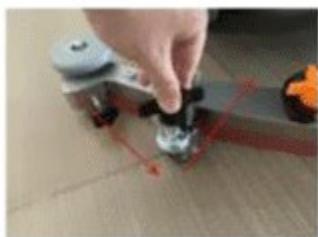 Close-up of a hand using a tool to adjust a small mechanical component (no visible text or symbols)