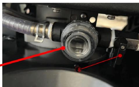 Close-up of a mechanical assembly with red annotation lines pointing to components (no readable text or symbols)