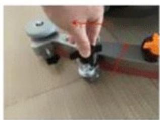 Close-up of a hand pressing down on a small mechanical component (no visible text or symbols)