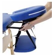 Close-up of a blue medical examination table with a hand adjusting the seat (no visible text or symbols)