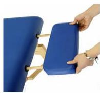 Close-up of hands holding a blue rectangular tray with wooden handles, against a white background (no text or symbols visible)