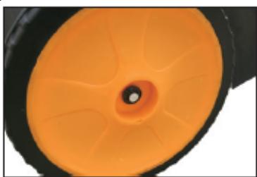 Close-up of a mechanical component with orange and black surfaces, no visible text or symbols